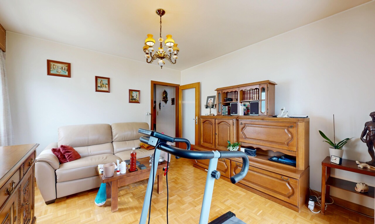 living room with parquet floors and a chandelier