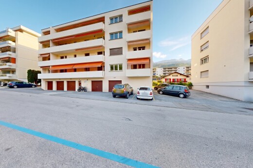 view of apartment building / complex featuring uncovered parking