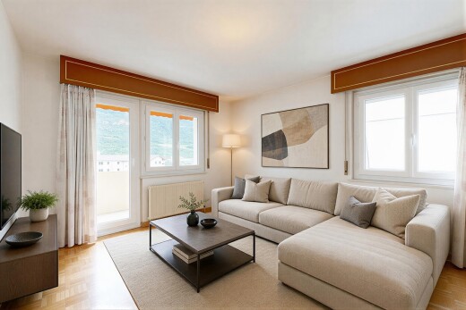 living area featuring parquet floors, suspended lighting, and radiator