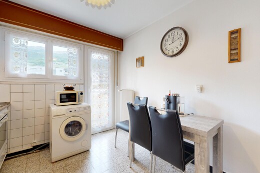 dining area with washer / dryer, radiator, and tile walls