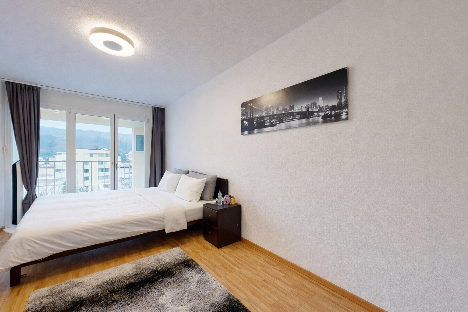 room / bedroom featuring wood finished floors and baseboards