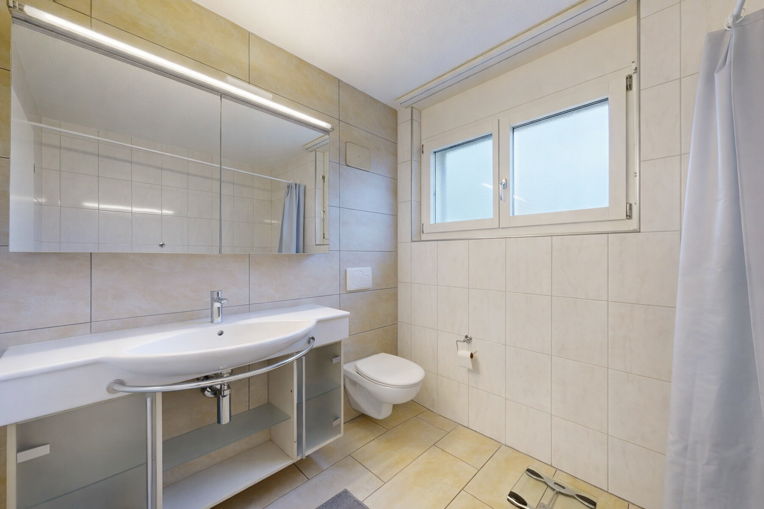 full bath with tile walls, light tile patterned flooring, and tiled shower