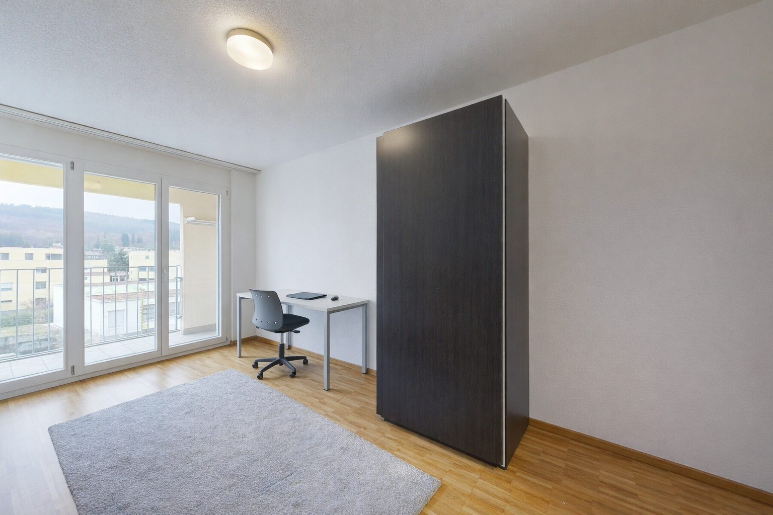 office featuring light wood-style flooring and a textured ceiling