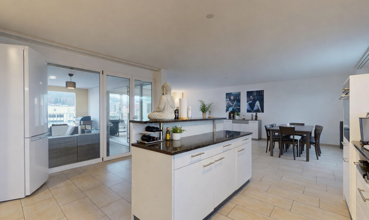 kitchen with white cabinets, freestanding refrigerator, dark stone counters, a center island, and open floor plan