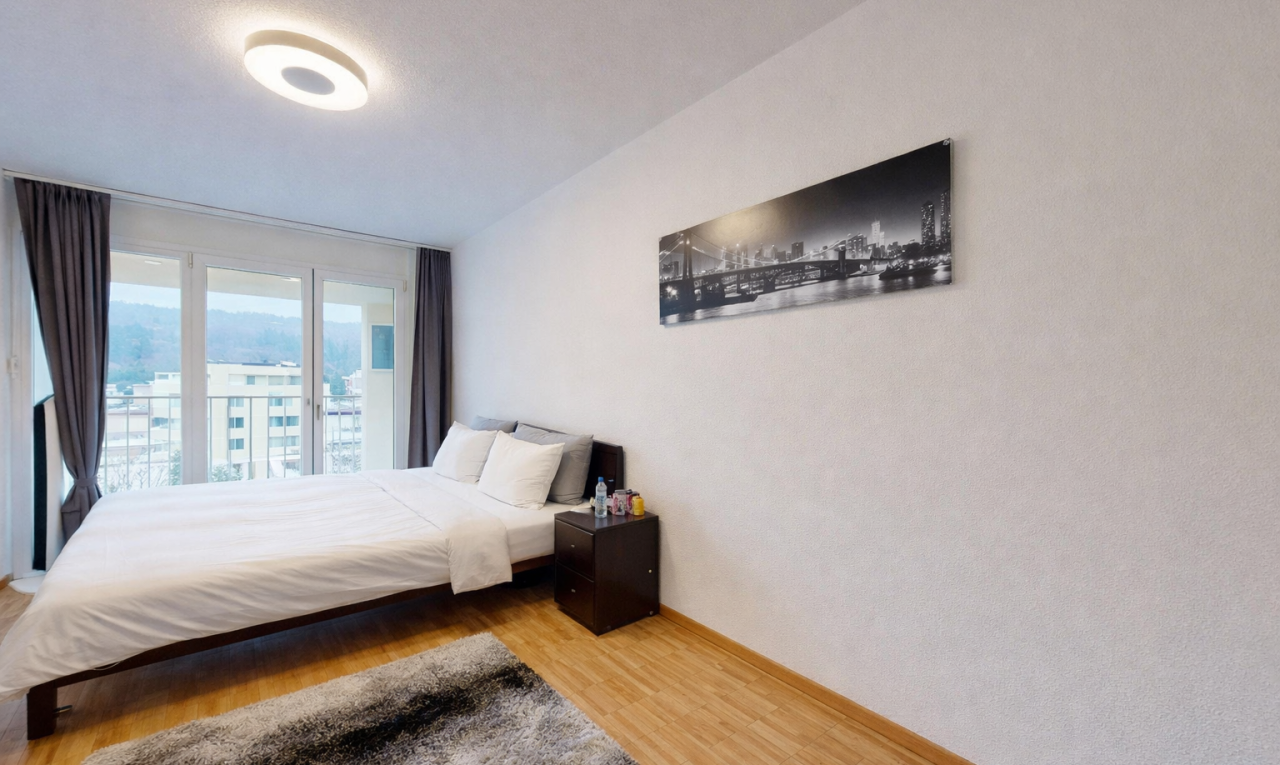 room / bedroom featuring wood finished floors and baseboards