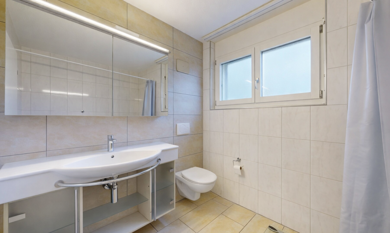 full bath with tile walls, light tile patterned flooring, and tiled shower