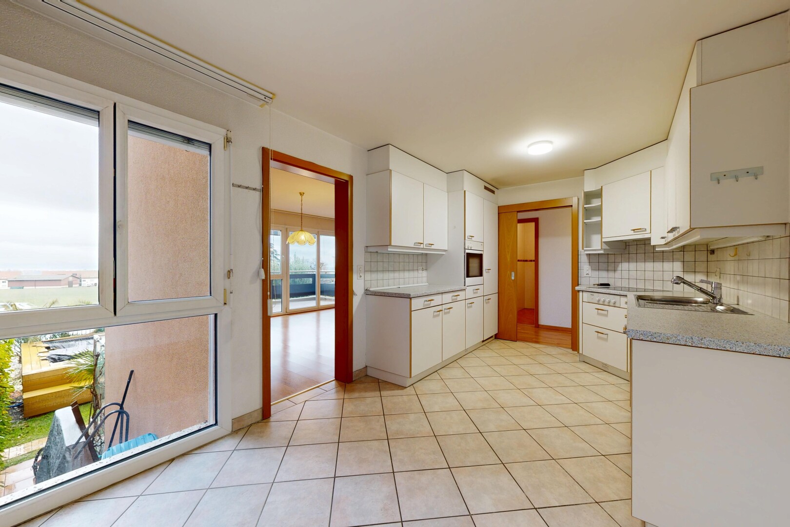 kitchen featuring white cabinets, tasteful backsplash, and light tile patterned floors