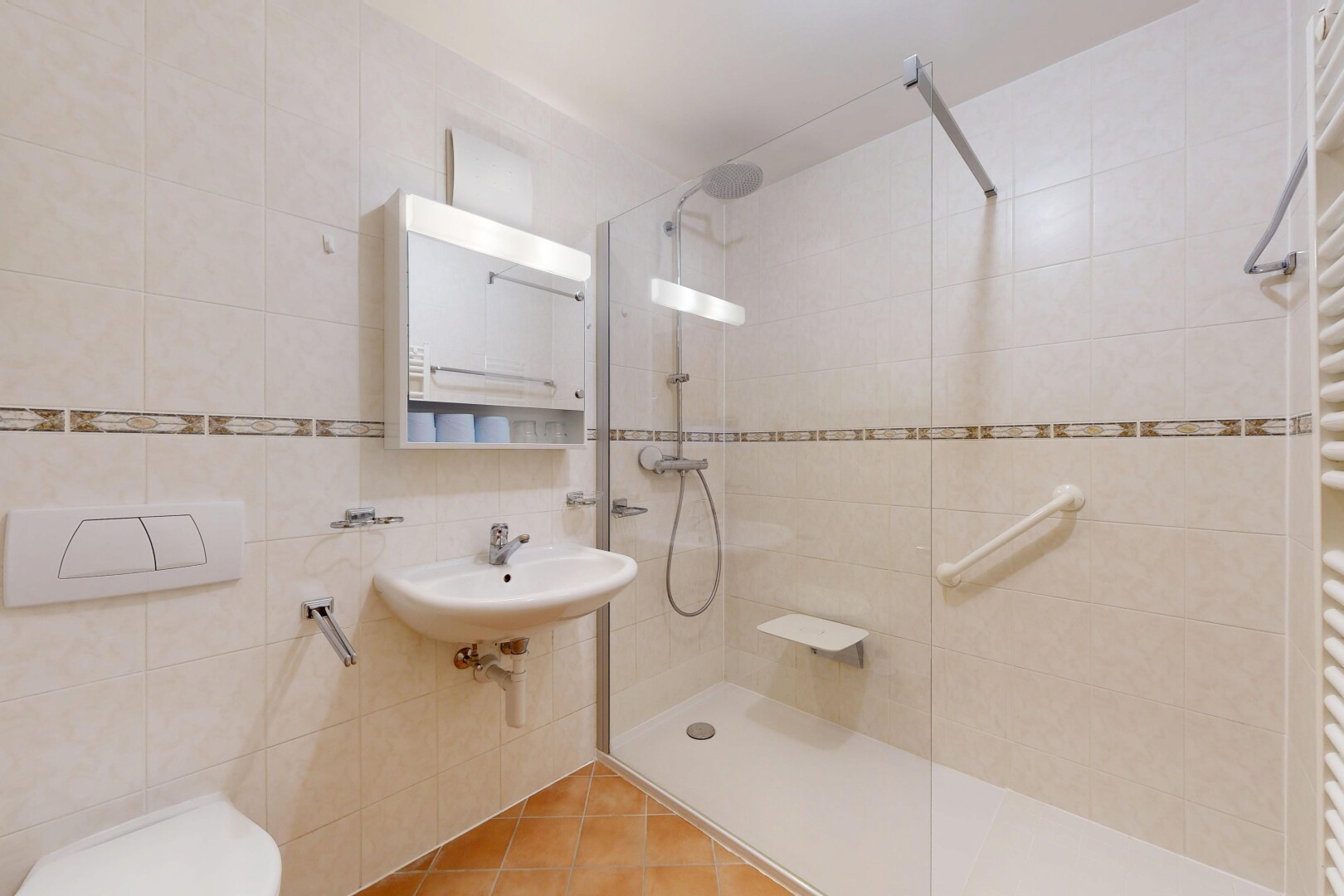 full bathroom featuring a towel warming rack, tile walls, walk in shower, radiator heating unit, and tile patterned flooring