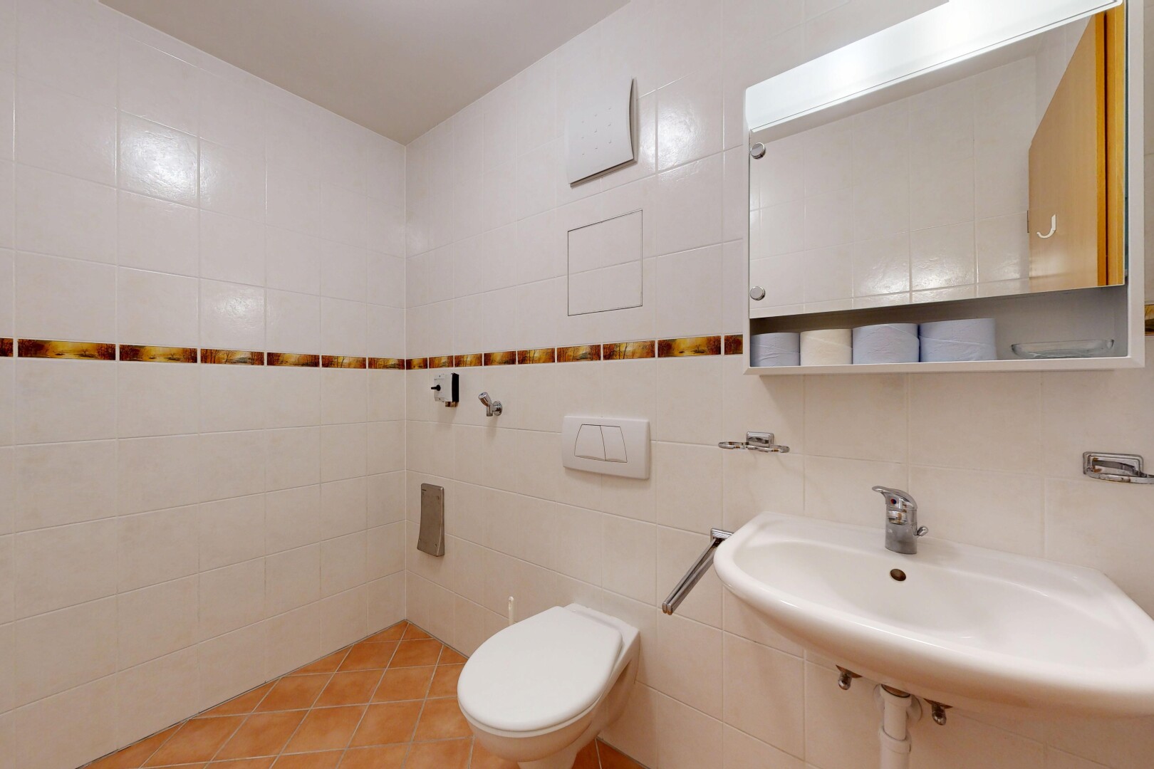 bathroom with a sink and tile walls