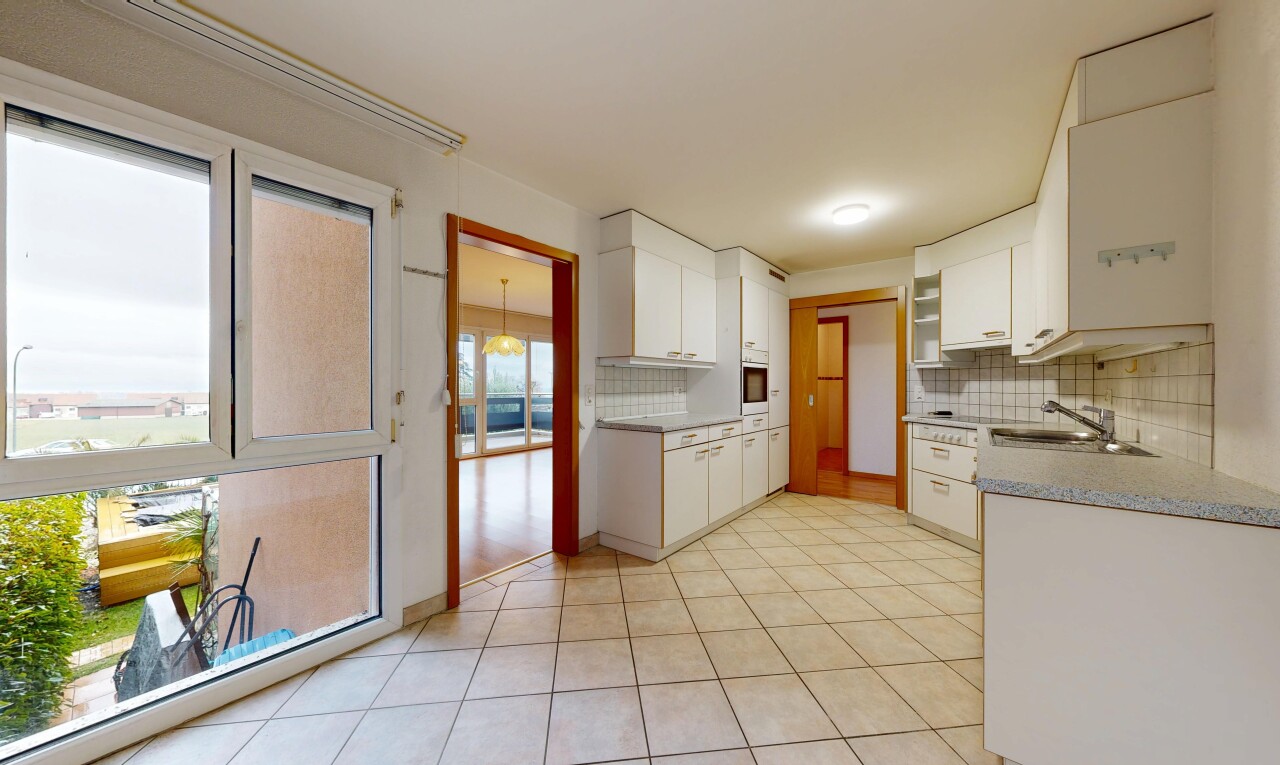 kitchen featuring white cabinets, tasteful backsplash, and light tile patterned floors