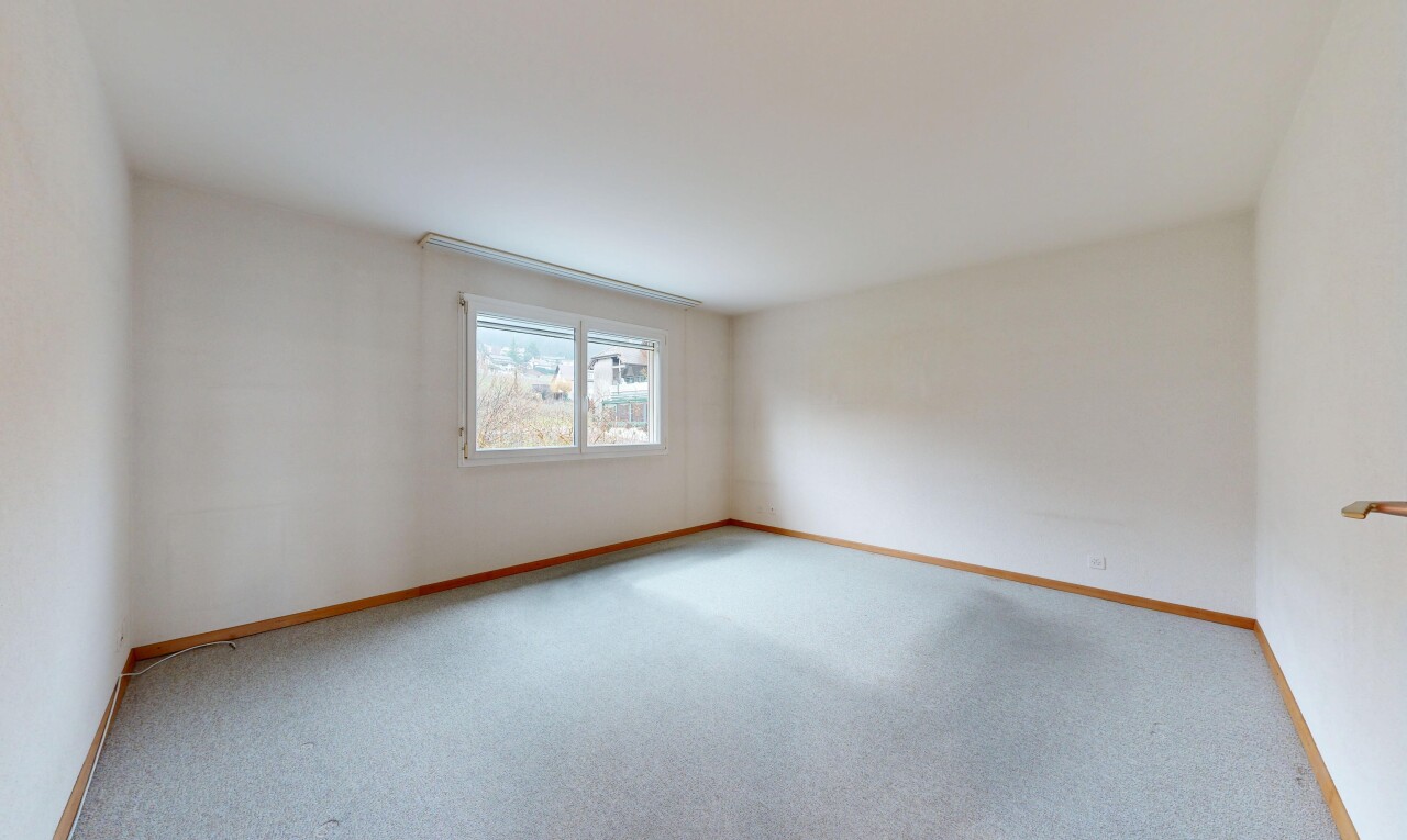 carpeted spare room featuring baseboards