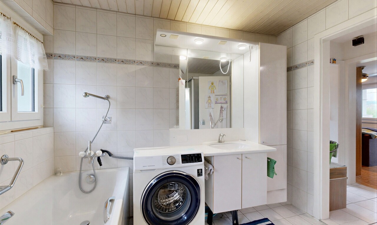 buanderie avec lumière naturelle, natural light, mur en carrelage, tile wall, et lave-linge et sèche-linge