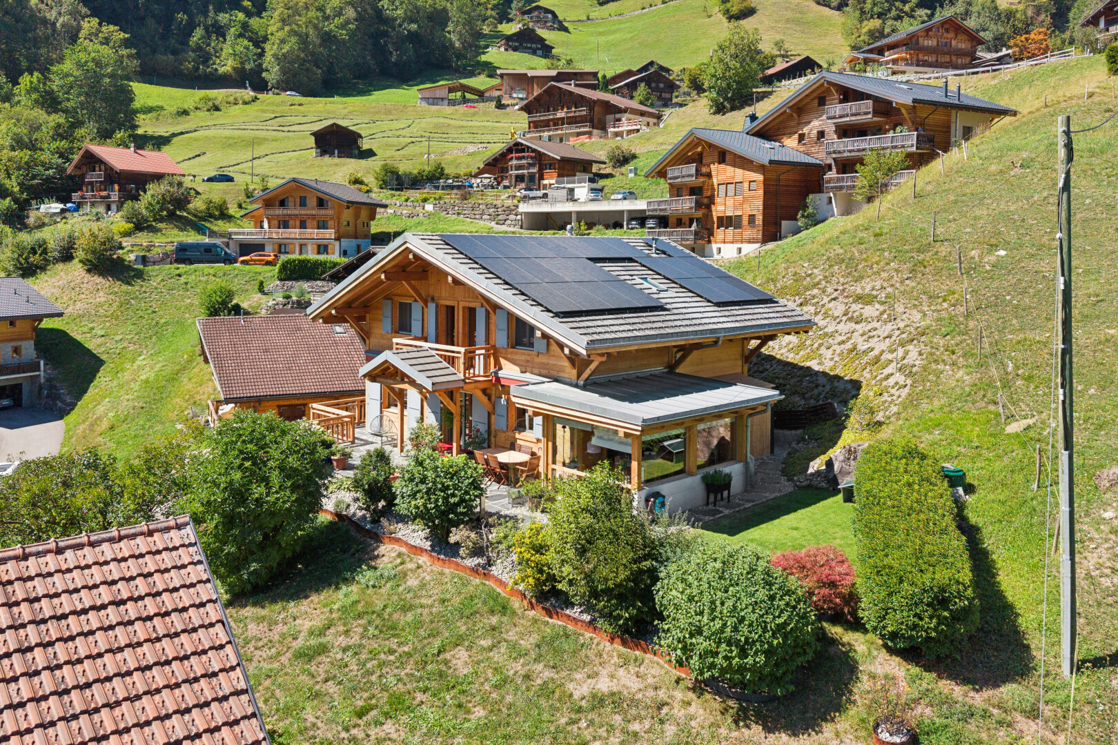 view of home with solar panels, covered porch, and a lawn