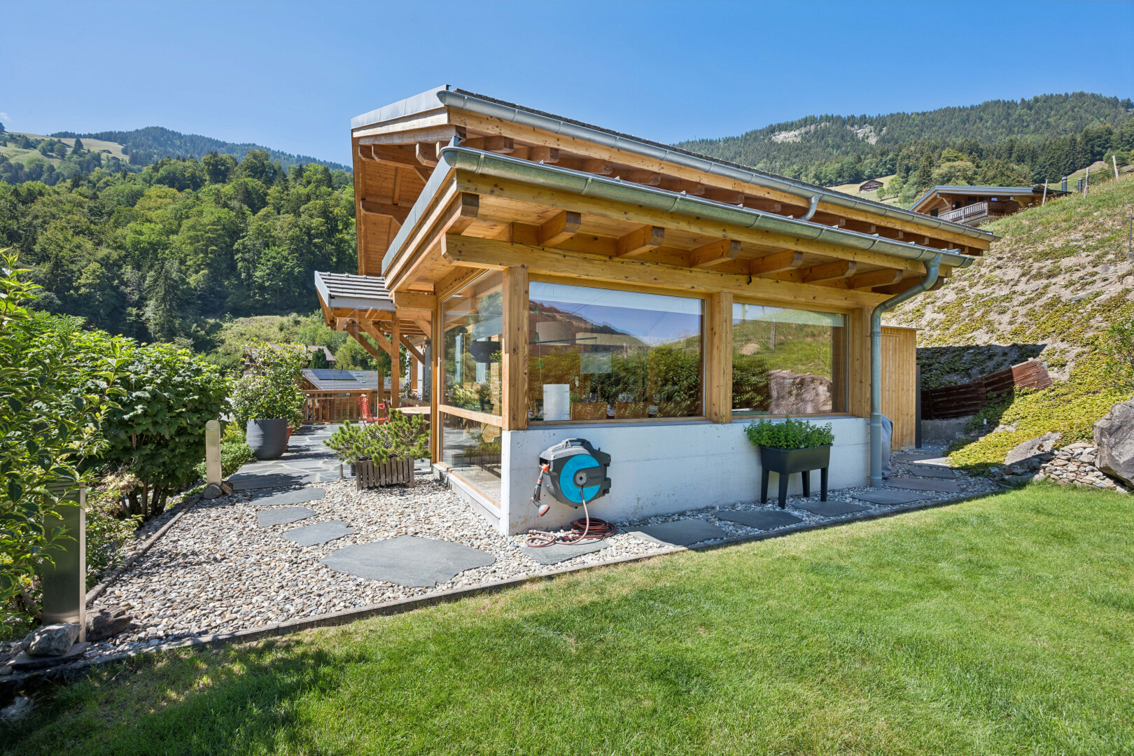 outdoor house with a lawn and a mountain view