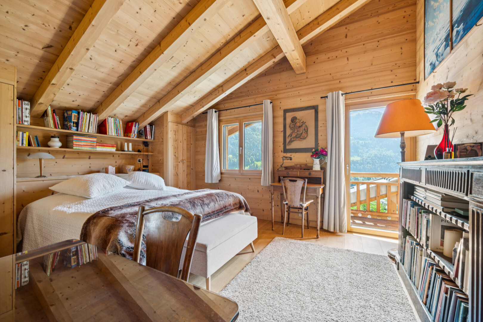 room featuring lofted ceiling with beams, wood walls, wood ceiling, light wood-type flooring, and access to outside