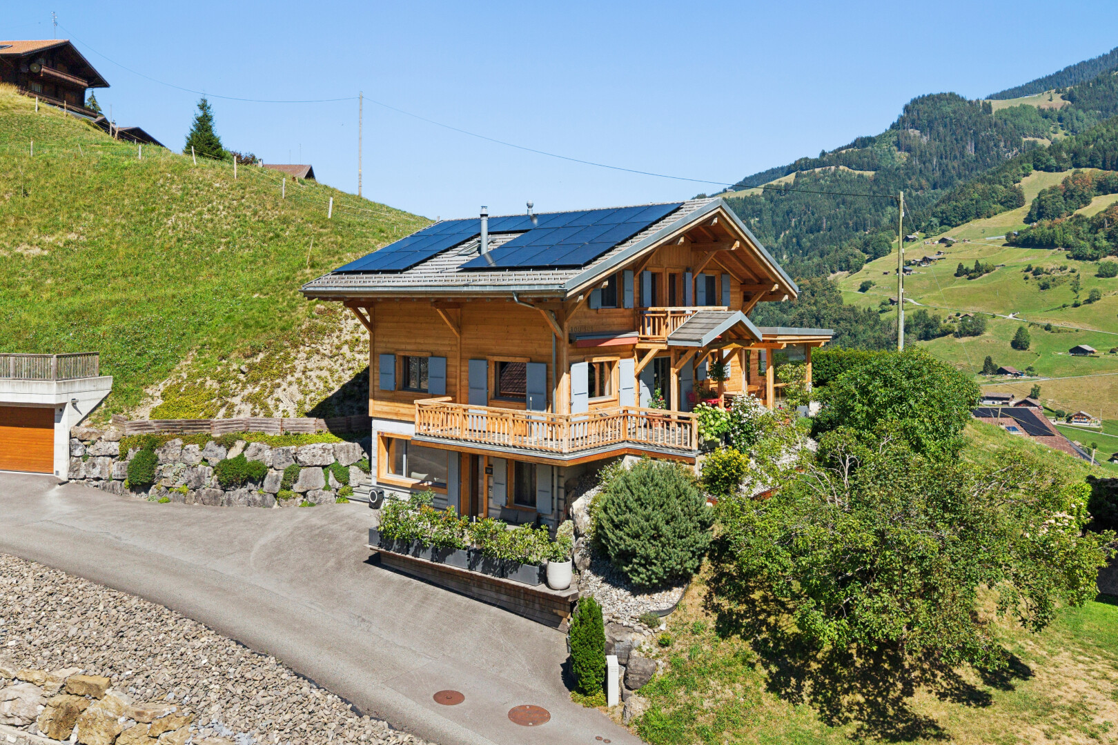 view of property with roof mounted solar panels and driveway