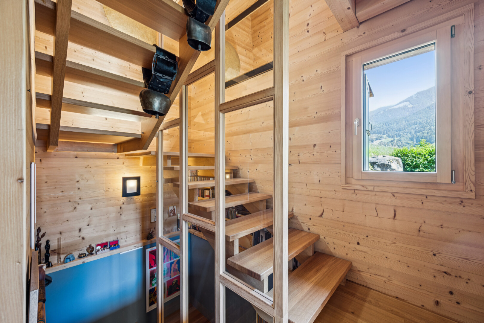 stairway featuring wooden walls and a mountain view