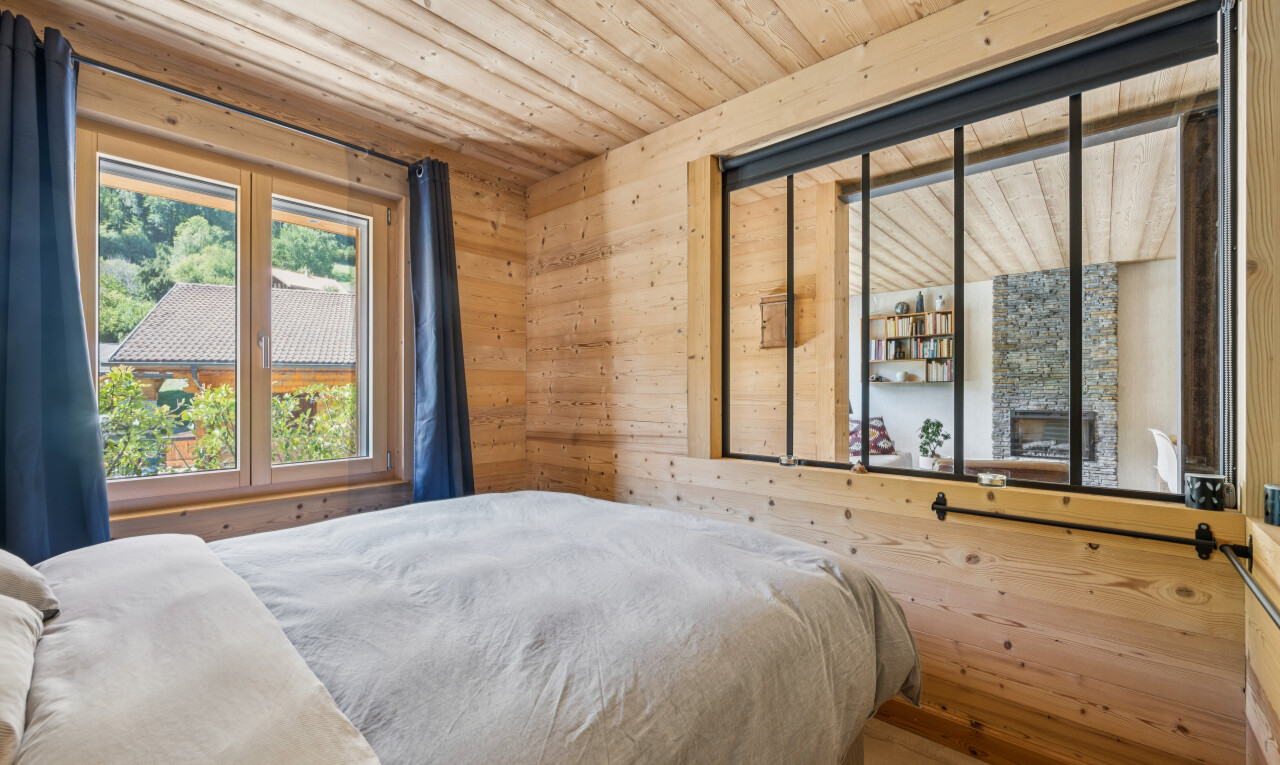 room / bedroom with wooden walls, wood ceiling, and wood finished floors