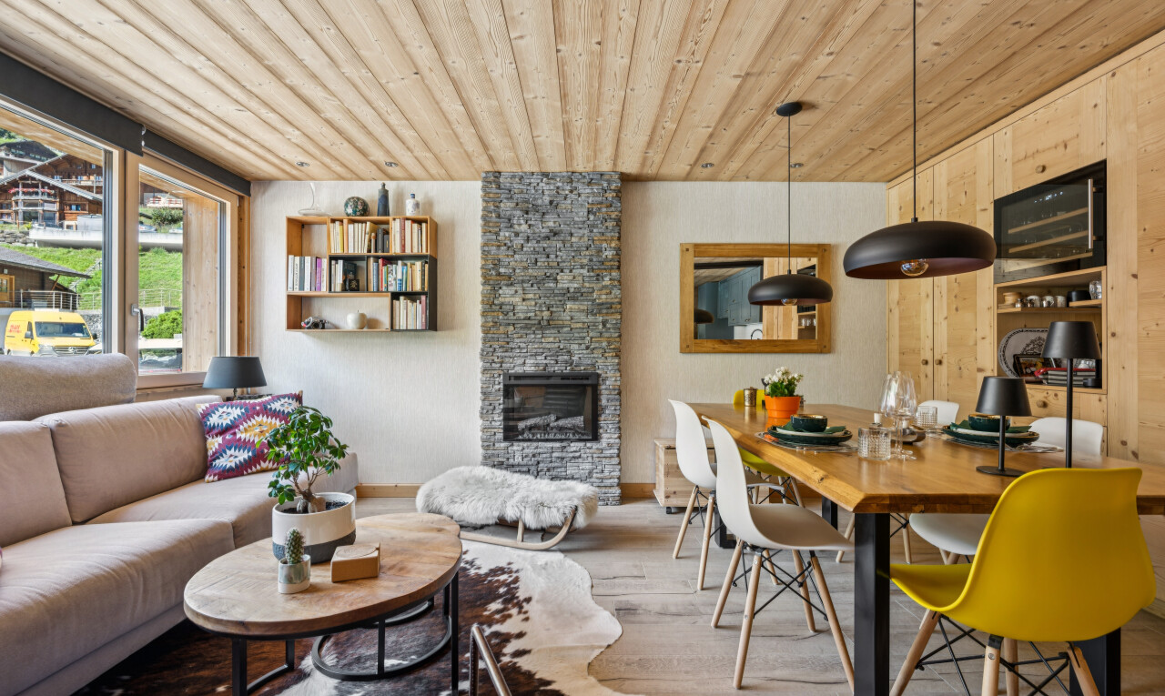 living room with a fireplace, wood ceiling, decorative light fixtures, and built in shelves