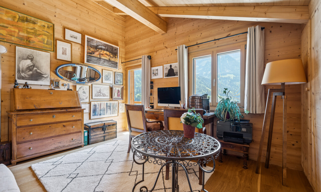 living area featuring lofted ceiling with beams, wood finished floors, wooden walls, and wooden ceiling