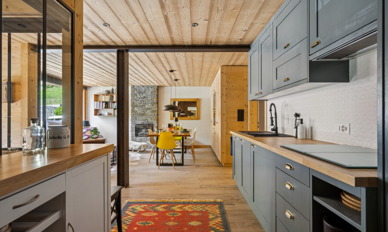 kitchen with butcher block counters, wood ceiling, gray cabinetry, light wood finished floors, and a fireplace