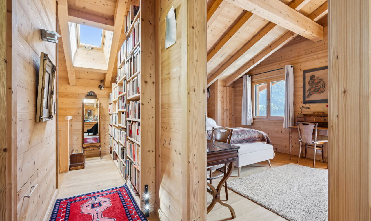hall with lofted ceiling with beams, light wood-type flooring, and wood walls