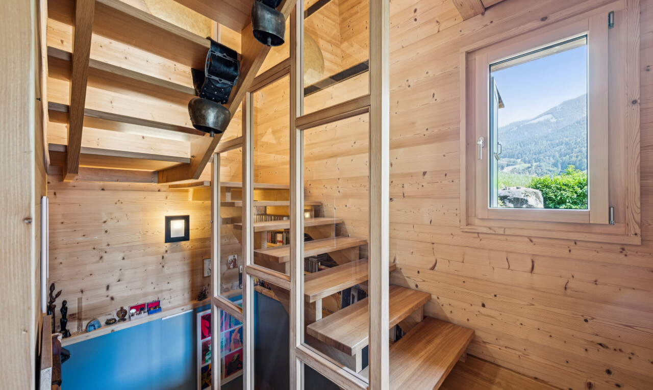 stairway featuring wooden walls and a mountain view