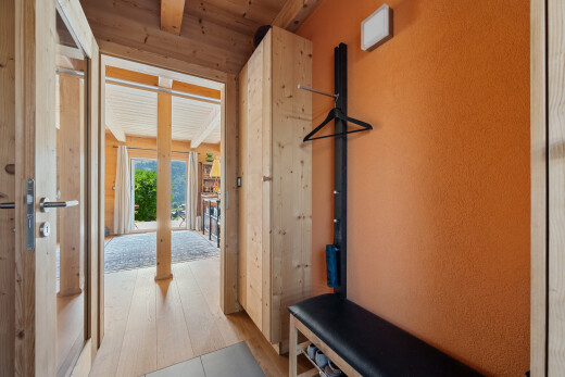 hall featuring a wood ceiling with exposed beams and light wood finished floors