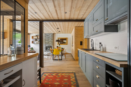 kitchen with butcher block counters, wood ceiling, gray cabinetry, light wood finished floors, and a fireplace