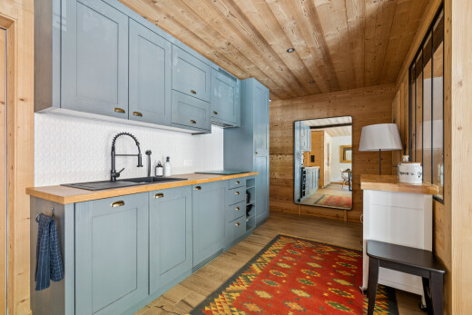 kitchen featuring wood ceiling, butcher block counters, light wood finished floors, wood walls, and blue cabinets