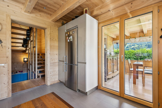 kitchen featuring a wooden ceiling with exposed beams and wood walls