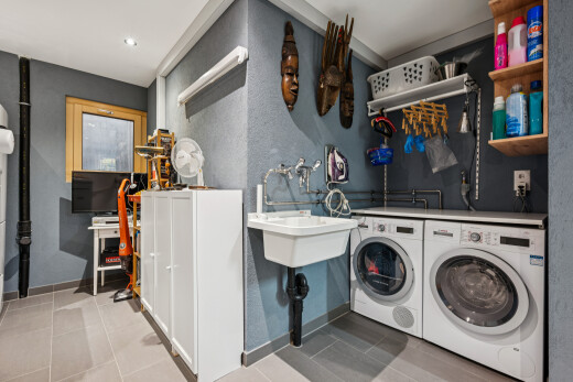 laundry room featuring recessed lighting, washer and dryer, and light tile patterned floors