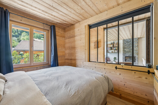 room / bedroom with wooden walls, wood ceiling, and wood finished floors