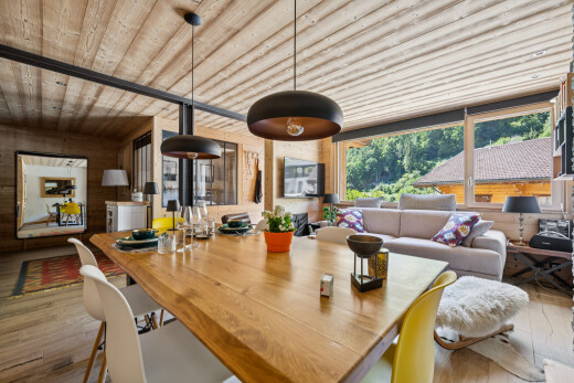 living area with wooden ceiling, decorative light fixtures, and light wood-style floors
