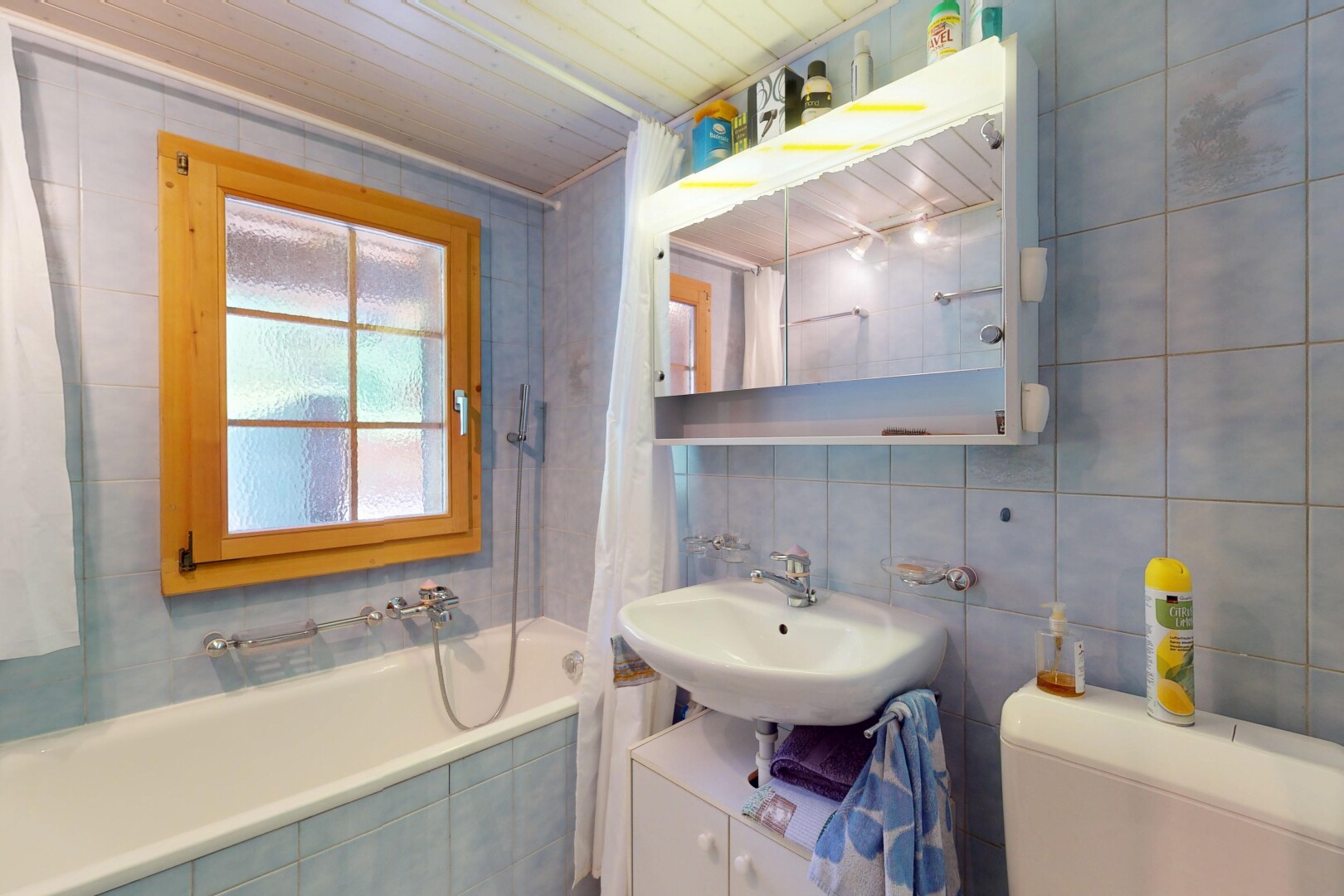 salle de bains avec mur en carrelage, tile wall, miroir, douche-bain combinés, et salle de bain complète