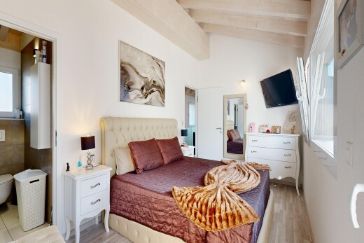 room / bedroom featuring lofted ceiling with beams and light wood-type flooring