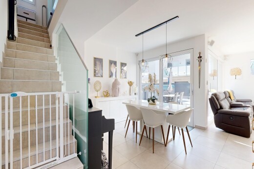 living area with light tile patterned floors and stairway