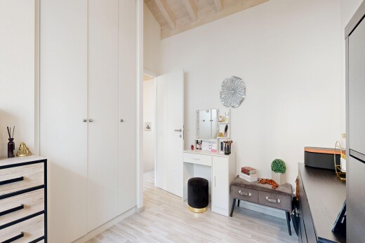 room / bedroom featuring light wood-type flooring and beamed ceiling