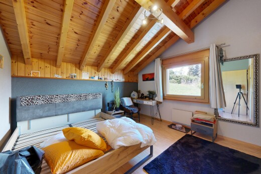 room with wood ceiling, vaulted ceiling with beams, and wood finished floors