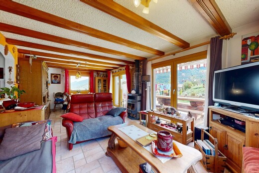 living area with beamed ceiling