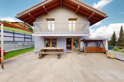 view of property with a balcony and a patio area