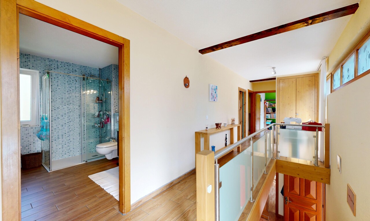couloir avec wood finish floor, sol en finition bois, inside property, drywall, et cloison sèche