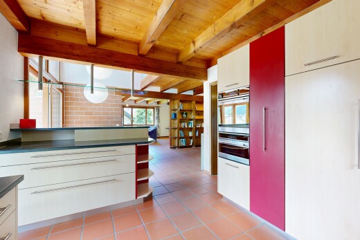 küche mit dark countertops, arbeitsplatten, light floor, two heights countertops, und natural light