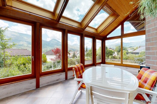 dining space with a mountain view, a skylight, and light tile patterned flooring