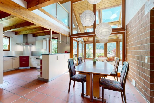 dining area with light tile patterned flooring and brick wall