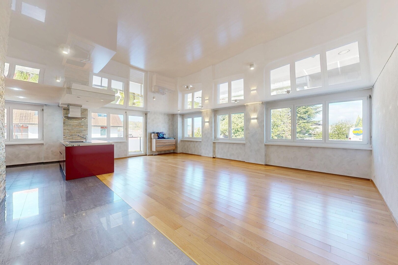 empty room featuring a high ceiling and light wood-style floors