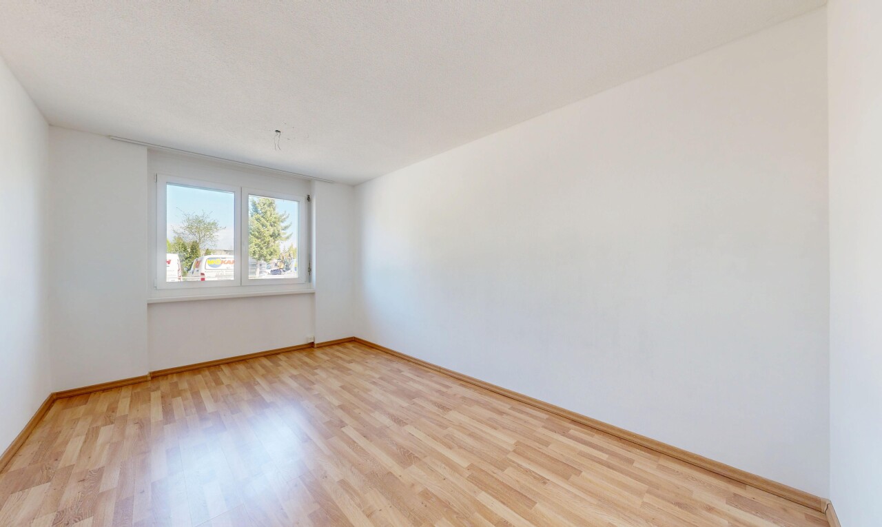 spare room featuring light wood-style flooring and baseboards