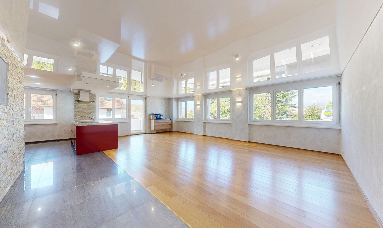 empty room featuring a high ceiling and light wood-style floors