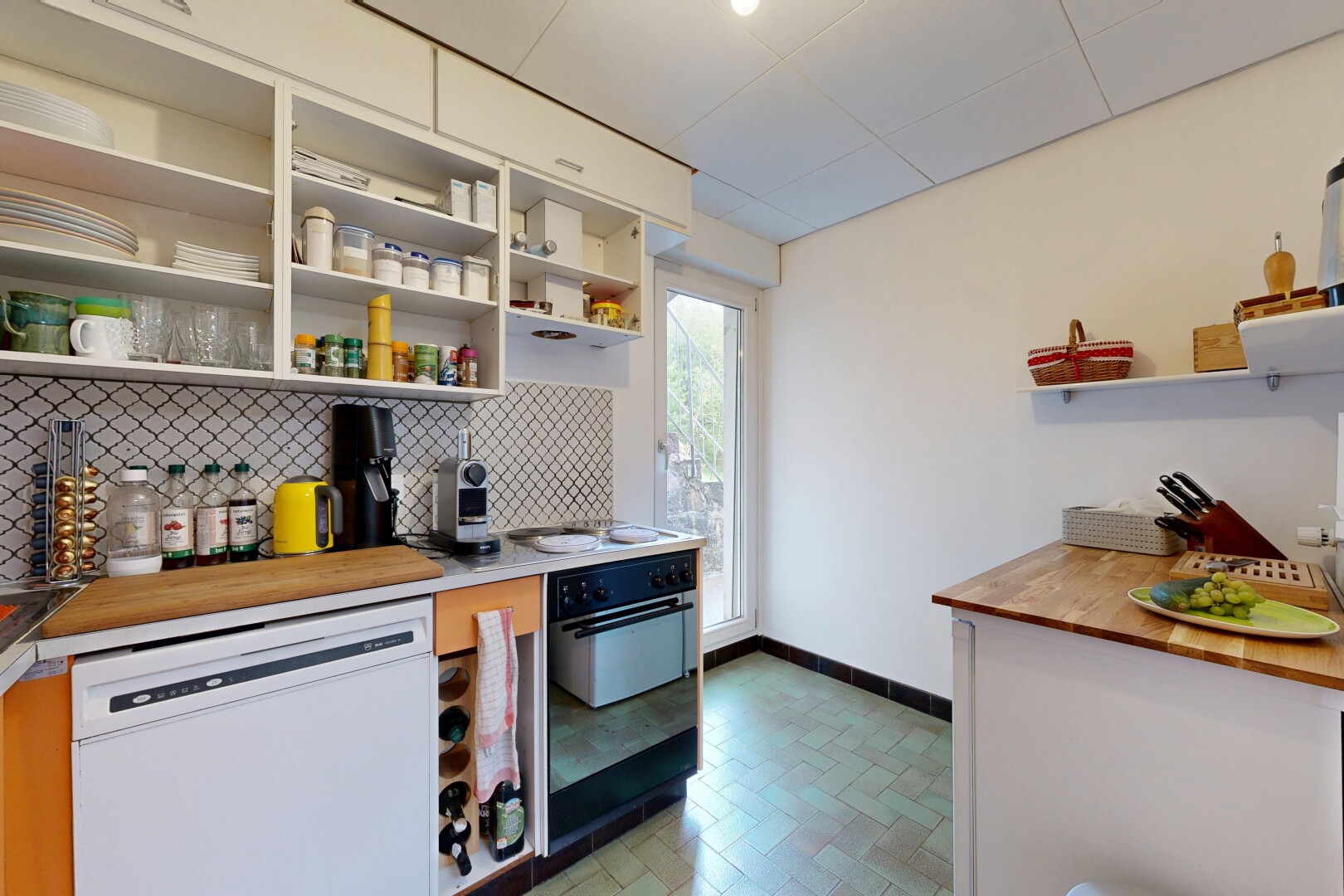 kitchen with open shelves, wood counters, dishwasher, oven, and backsplash