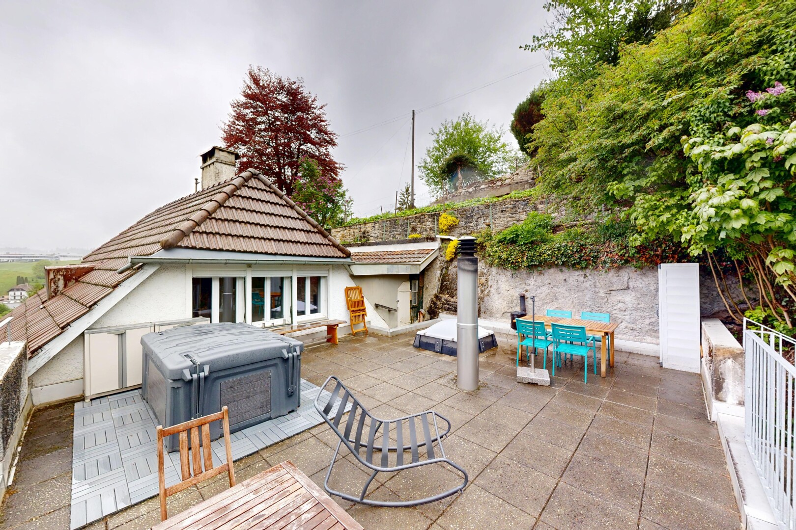 terrace with outdoor dining area, a hot tub, and a patio